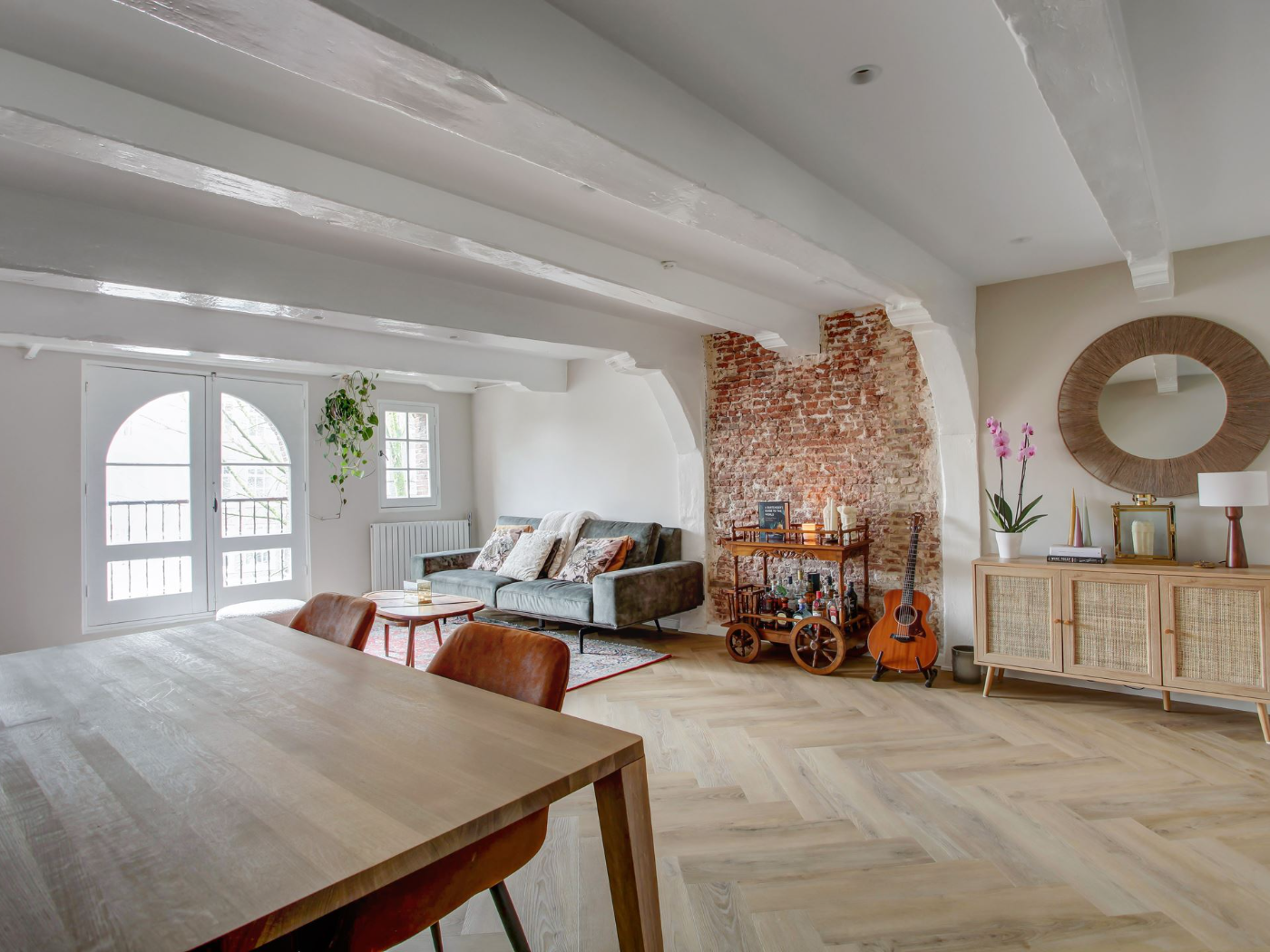 Rechtboomssloot project — living room with exposed brick